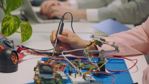 Electronics Assembly: Soldering Circuit Board at Desk