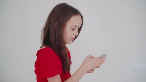 Girl Focused On Her Mobile Phone At Home