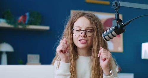 Woman Speaking Into Microphone in Home Studio