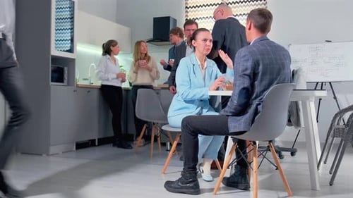 Male Colleagues and Businesswoman Sharing Coffee and Food During Office Lunch Break