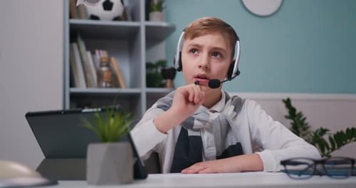 Focused Boy Studying at Desk at Home