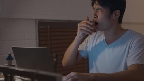 Man Typing on Laptop at Night Indoors