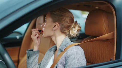 Woman Applies Lipstick Inside Her Car Before Driving