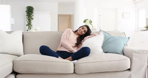 Woman Relaxing on Couch in Bright Living Room