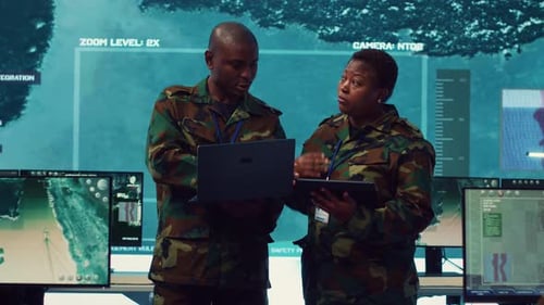 Military Personnel Discussing Technology in a Command Center