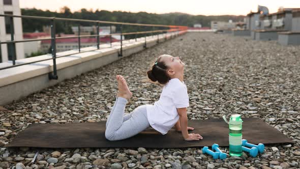 Young Girl Practicing Yoga Outdoors Performing Advanced Backbend Pose ...