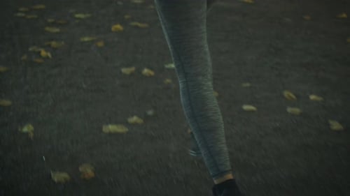 Follow Shot of Woman Running in Park at Bright Sunny Day