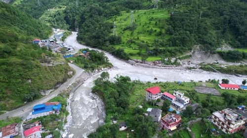 Beautiful aerial landscape of Gandaki River and Marpha Village houses on the riverside, drone fly ov