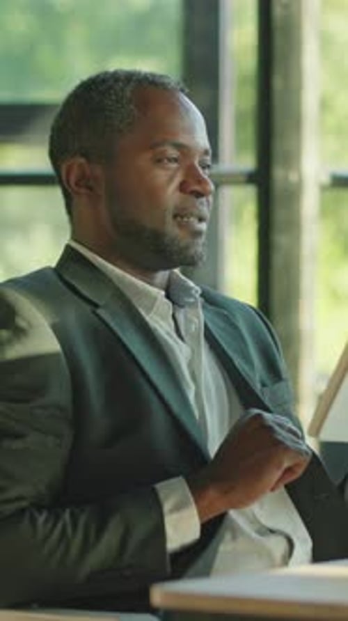 Professional Man Uses Tablet in Modern Office