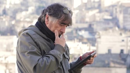 Man Using Tablet in Urban Outdoor Environment