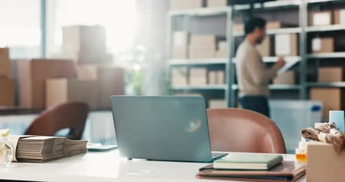 Warehouse Workplace with Boxes and Laptop on Desk
