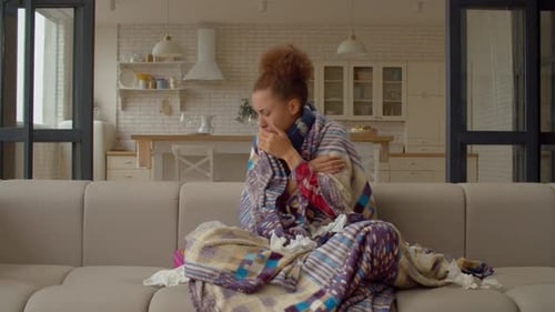 Sick Black Woman Suffering From Flu Virus Sneezing and Blowing Nose in Tissue