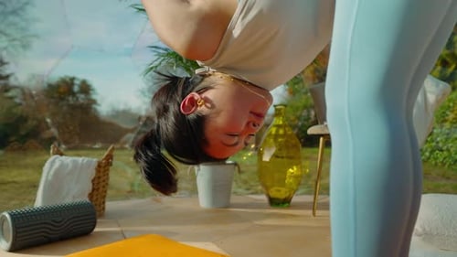 Young asian woman doing yoga poses. stretching and breathing exercises in garden conservatory, sunny