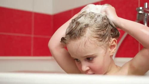 Child Happily Washing Hair in Bathtub