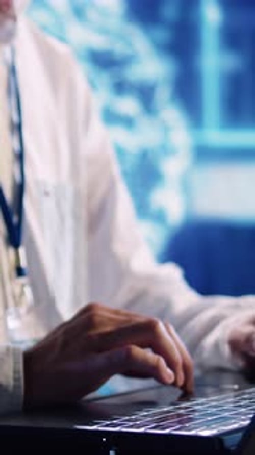 Hands Typing on Laptop in Clinical Setting