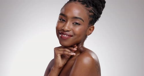 Woman, portrait and happy with skincare in studio for glowing skin, wellness