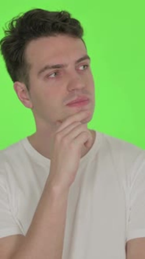 Thinking Young Man with New Idea on Green Background, Vertical Video