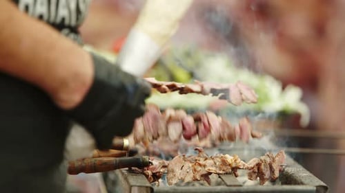 Cooking Meat Skewers on a Grill in Urban Setting