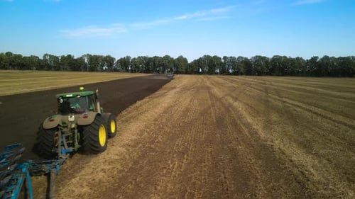 Tractors plowing the field in Ukraine