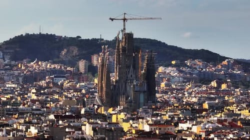Aerial Cinematic Footage of Famous Cathedral in Construction Sagrada Familia at Golden Hour