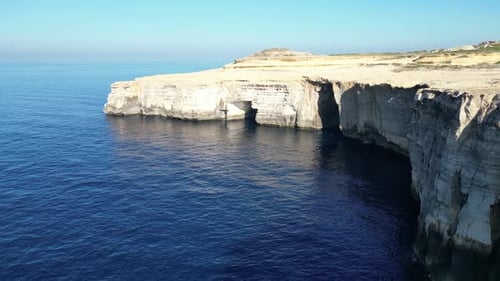 Aerial drone view of cliffs in Malta and the Mediterranean Sea