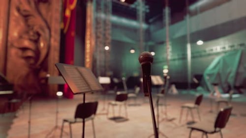 Microphone on Stage in Empty Concert Hall Awaiting Performance