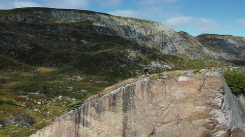 Drone Shot of Woman in Nordic Sweater Hike on Hill
