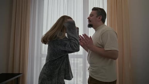 Couple in Conflict: Woman Reacts Angrily to Man