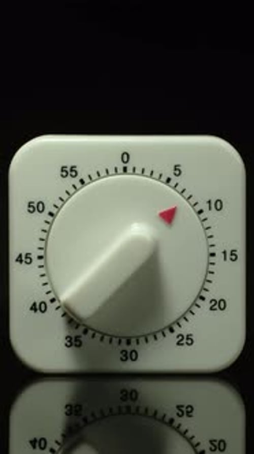Time lapse of a kitchen clock timer countdown to zero.