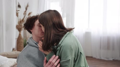 Loving Couple Sharing a Tender Kiss Indoors