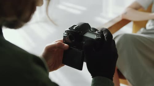 Photographer Adjusts Camera Reviewing Monochrome Photos