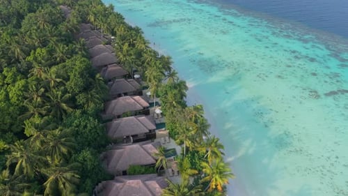 Aerial View of Maldives Island Resort Showcasing Overwater Bungalows and Pristine Beaches