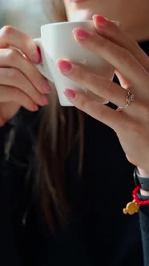 Beautiful girl drinking coffee in a cafe.
