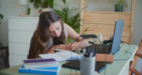 Woman Studying at Home, Using Laptop and Notebook