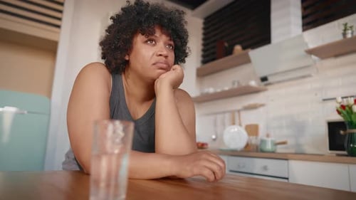 Hormonal Mood Swings in Pregnancy Portrait of Sad Black Woman Drinking Water Unhappy Depressed Lady