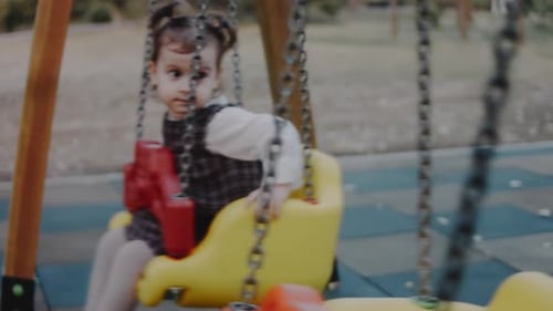 Cute Adorable Toddler Girl Swinging on Outdoor Playground Happy Smiling Baby Child Sitting in Chain