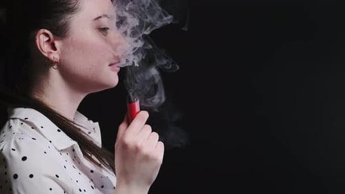 Young Woman Exhaling Vape Vapor, Close Up
