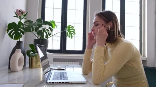 Woman Working at Home With Headache