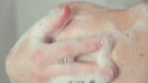 Woman's Arm and Shoulder Being Lathered with Soap