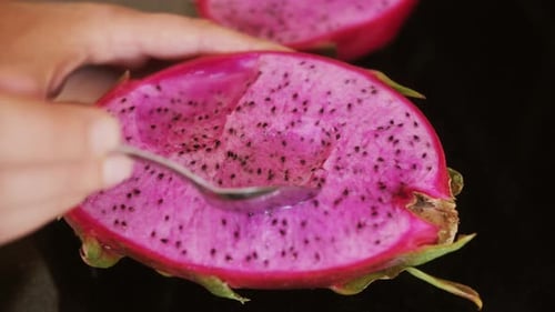 Person Eating Dragon Fruit or Pitaya with a Spoon Close Up of Fresh Exotic Fruit