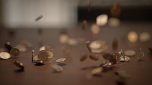 Coins Falling and Spreading Across Surface
