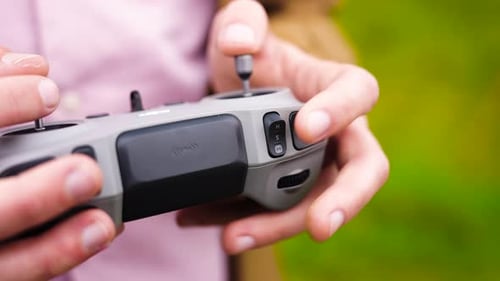 Person use joysticks on remote control