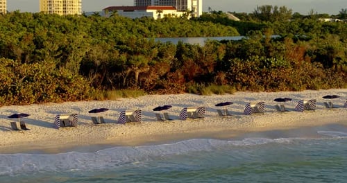 Aerial Shot Of Beach Chairs On Naples Florida Beach At Sunset