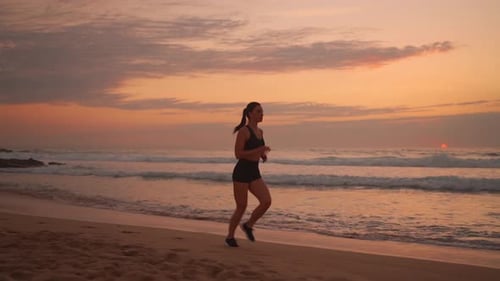 Woman Running Alone at Beautiful Sunset on Beach