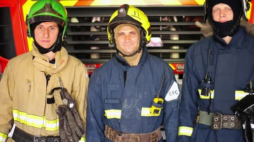 Brave Firefighters Standing in Front of Fire Truck