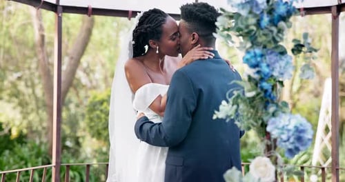 Loving Couple Embrace and Kiss at Outdoor Wedding