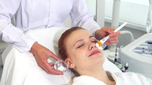 Woman Getting Facial Mask Treatment at Spa