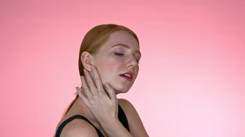 Auburn Haired Woman Posing on Pink Background
