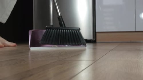 Woman Sweeping Floor with Broom and Dustpan Indoors