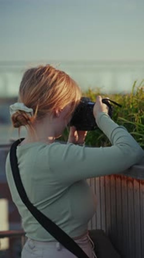 Girl Photographer Shooting Green Plants On Rooftop